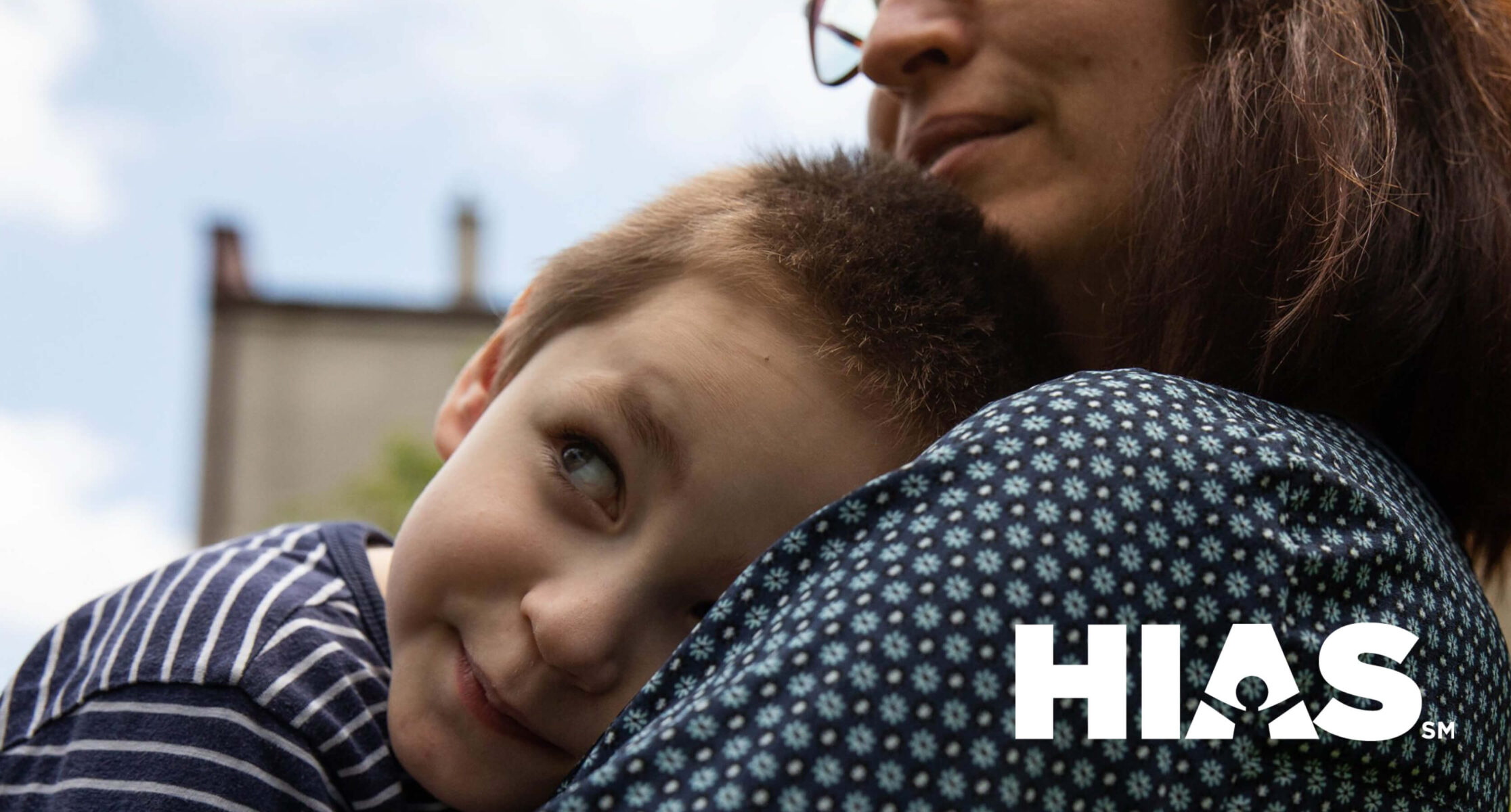 HIAS logo over mother and son