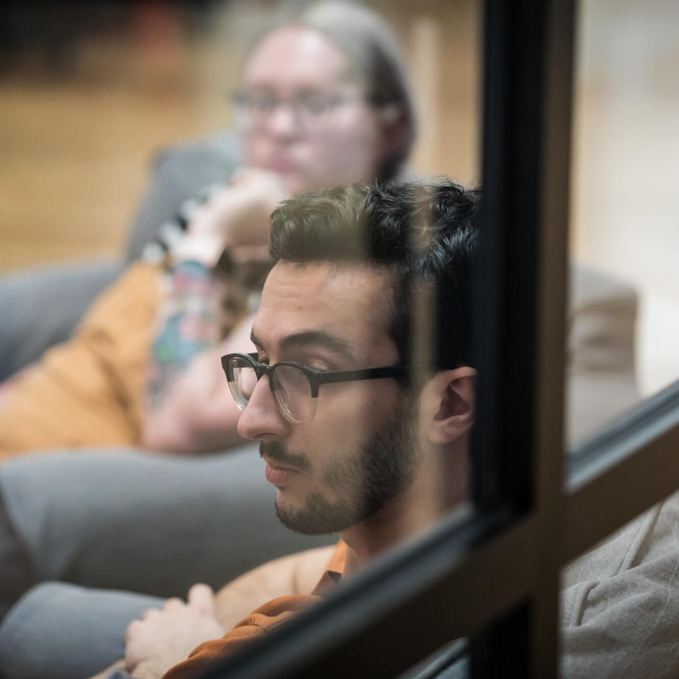 Corey behind a window