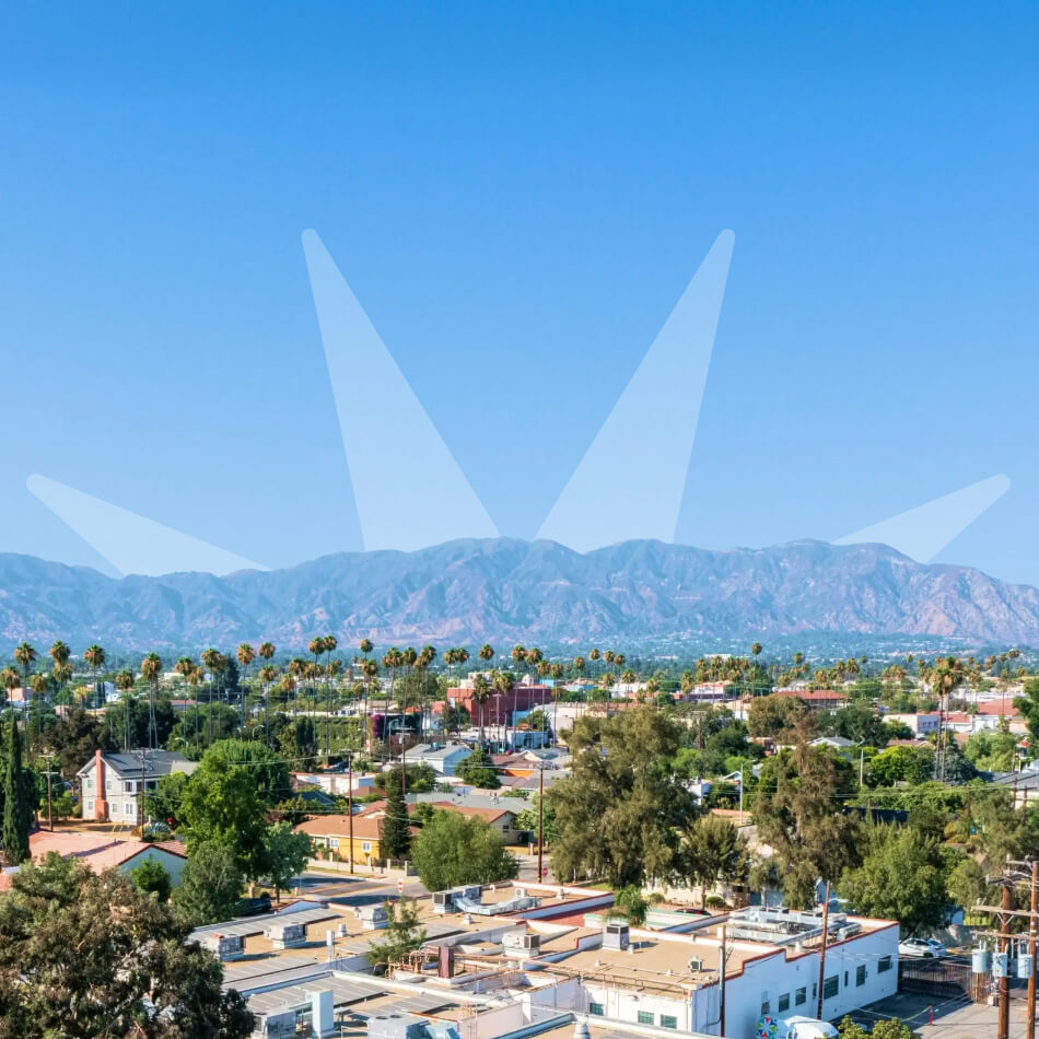 Sunburst logo coming up behind mountains